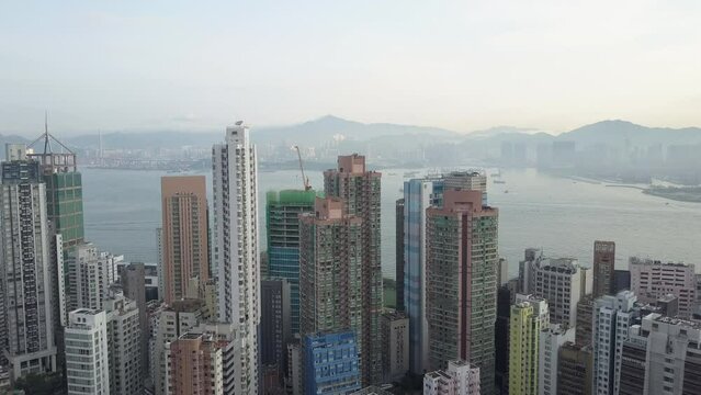 Aerial Backward Shot Of Modern Residential Buildings In City By Sea - Hong Kong, China