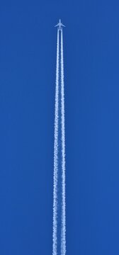 chemtrails denier conspiracist contrail plane reaction contrail condensation on blue background