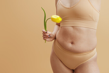 Body imperfections. Real human skin without retouching, acne, stretch marks, cellulite and excess weight. Body Positivity. Photo of chubby overweight woman, poses in lingerie - obrazy, fototapety, plakaty