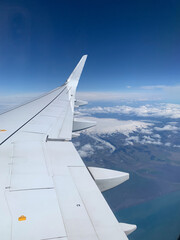view from aircraft to the ocean and snow covered landscape of Iceland - 767075167