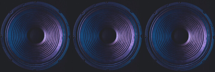 Close-up of speakers membrane on black background with colored lighting. - obrazy, fototapety, plakaty