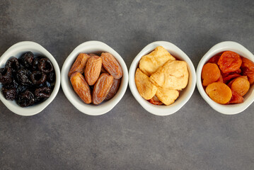 Photo of dried fruits, dates, dried apricots, dried plums, dried peach.