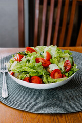 Green vegan salad from green leaves mixes and vegetables. Vegan food on the table.