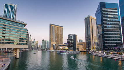 Fototapeta na wymiar Dubai Marina towers and canal in Dubai day to night timelapse