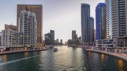 Fototapeta na wymiar Dubai Marina towers and canal in Dubai day to night timelapse