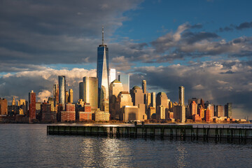 Cityscape of Lower Manhattan at sunset. New York City skyscrapers and World Trade Center from across the Hudson River