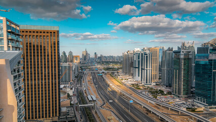 Aerial view of Dubai marina skyscrapers and Jumeirah lakes towers timelapse with traffic on sheikh...