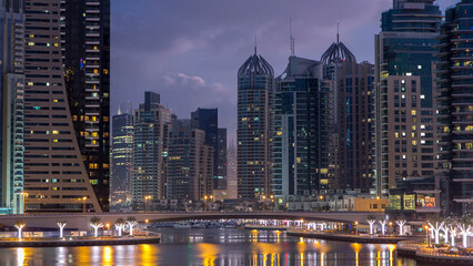 Dubai Marina towers and canal in Dubai night to day timelapse