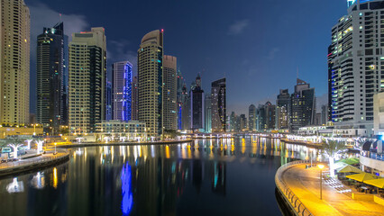 Fototapeta na wymiar Dubai Marina towers and canal in Dubai night to day timelapse