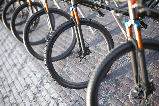 Intricate Detail of Parked Bicycles on a Cobbled Street, Highlighting Wheels