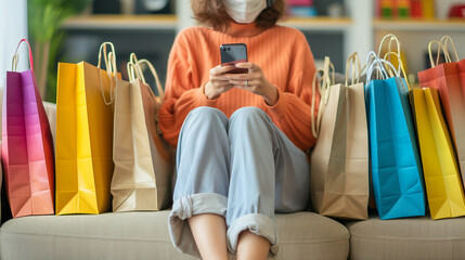 A shopaholic woman consumer using smartphone to buy online e-commerce while sitting among various sizes of shopping bags - obrazy, fototapety, plakaty
