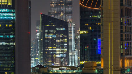 Dubai downtown architecture at night timelapse. Aerial view of numerous skyscrapers near Sheikh...