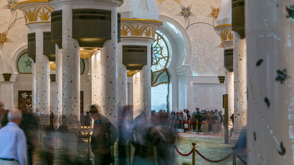 Magnificent interior of Sheikh Zayed Grand Mosque timelapse with crowd in Abu Dhabi.