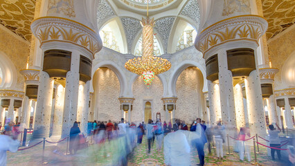 Magnificent interior of Sheikh Zayed Grand Mosque timelapse hyperlapse with crowd in Abu Dhabi.