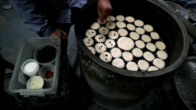Footage of Baker Adding Raisins on the Mid-baked Batter of Khanom Farang Kudeejeen, a Famous Portuguese Influenced Cupcakes in Thailand