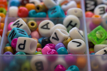 Colorful round rings and dice with letters to make jewelry bracelets for children