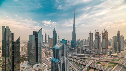 Naklejka na ściany i meble Dubai skyline timelapse at sunset with city center skyscrapers and Sheikh Zayed road traffic, Dubai, United Arab Emirates
