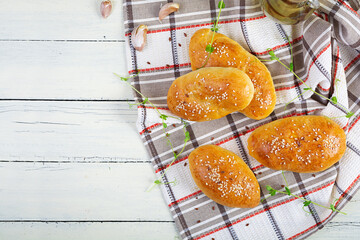 Cabbage pies on wooden background. Baked homemade pirozhki with cabbage