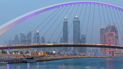 Pedestrian Bridge over the Dubai Water Canal day to night timelapse, United Arab Emirates