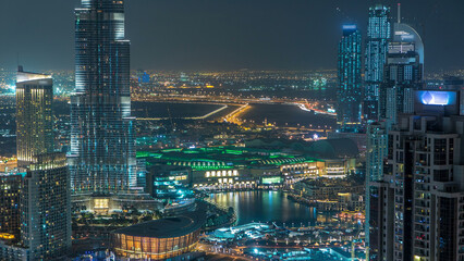 Aerial view of Dubai downtown Lake area night timelapse and skyscrapers