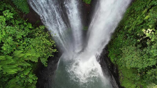 Tripod top view drone slowmo shot of Aling Aling waterfall. Bali, Indonesia.