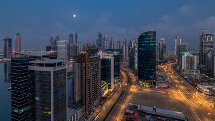 Fototapeta na wymiar Dubai Downtown night to day timelapse. Aerial view over big futuristic city by night.