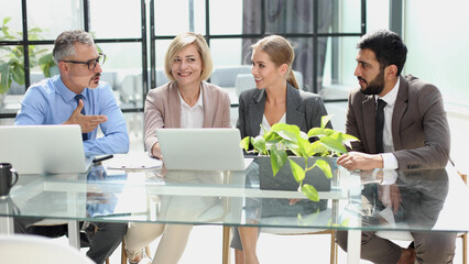 Portrait of creative business team using laptop