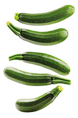 Falling zucchini isolated on white background, clipping path, full depth of field 