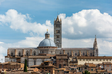 Fototapeta premium The historic city of Siena in the heart of Italy's Tuscany, with the famous cathedral of Santa Maria Assunta with its striped facade
