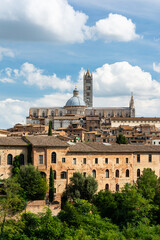 Fototapeta na wymiar The historic city of Siena in the heart of Italy's Tuscany, with the famous cathedral of Santa Maria Assunta with its striped facade