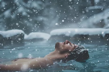Poster solo traveler relaxing in a natural hot pool during snowfall © studioworkstock