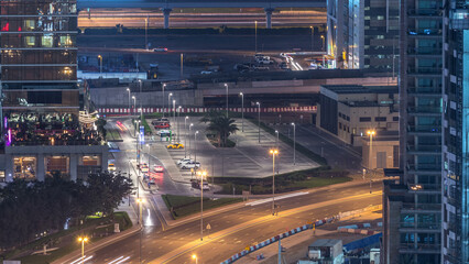 Birds eye view of Dubai skyline timelapse and rush hour traffic in downtown at night