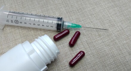 Medicine pills of various kinds and types with injections on a cloth background