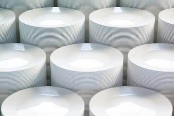 Neatly Arranged Stacks of Pristine White Ceramic Dinner Plates