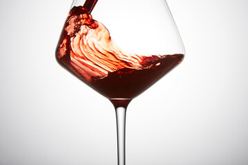 Red mature wine is poured into transparent glass. - 767107540