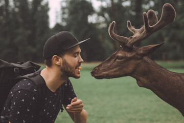 Man Feeding Deer in Blatna Castle Park, Czech Republic