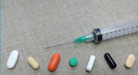 Medicine pills of various kinds and types with injections on a cloth background