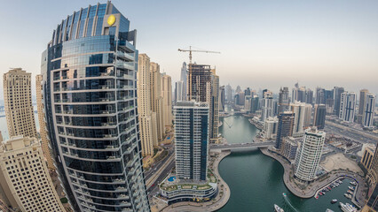 Beautiful aerial top view day to night transition timelapse of Dubai Marina canal