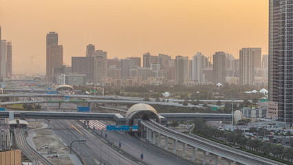 Aerial view of Jumeirah lakes towers skyscrapers during sunrise timelapse with traffic on sheikh zayed road.