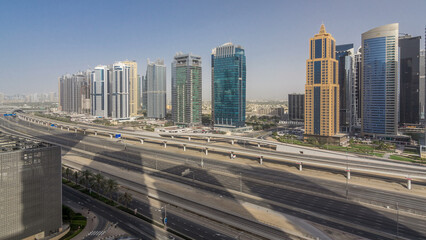 Aerial view of Jumeirah lakes towers skyscrapers timelapse with traffic on sheikh zayed road. - obrazy, fototapety, plakaty