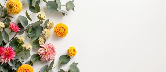 Round yellow and pink flowers incorporated into a floral arrangement with eucalyptus branches on a white backdrop. Presented as a flat lay with a top-down view and room for text.