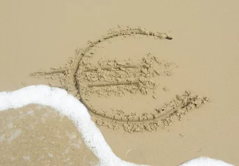 Fototapeten Cyntsa Eastern Cape South Africa - Euro sign written in the sand being washed away concept fiscal defiicit. © Richard