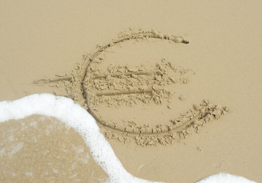 Cyntsa Eastern Cape South Africa - Euro sign written in the sand being washed away concept fiscal defiicit.