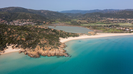 Aerial view of the Sardinian coast. Crystal clear sea of ​​Chia beach. Calm and sunny sea