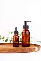 Set of natural organic SPA beauty products on wooden board isolated on white background. Amber glass spray bottle, homemade soap, serum. Bio cosmetics branding, packaging design..