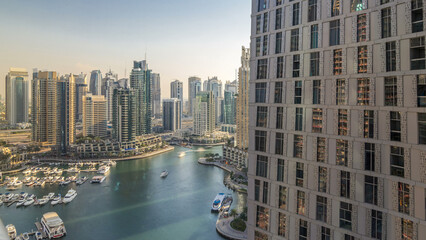 Beautiful aerial view of Dubai Marina promenade and canal with floating yachts and boats before...
