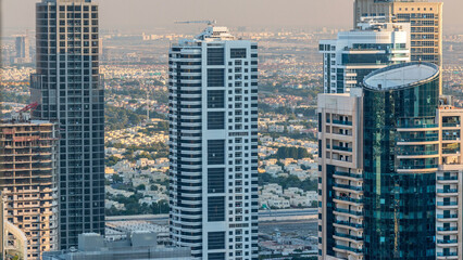 Dubai marina and JLT skyscrapers aerial skyline during sunset timelapse.