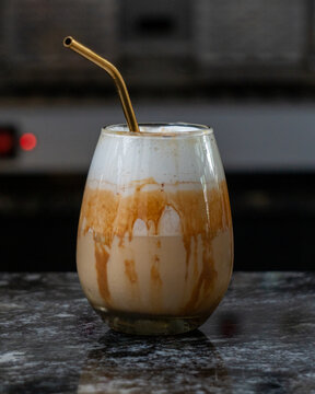 Cold beverage made out of coffee and milk from proffesional brewer of a coffee shop