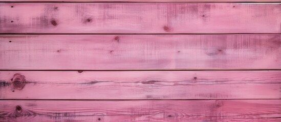 A close up of a pink wooden wall made from hardwood with tints and shades of magenta, violet, and purple. The wood stain adds depth to the rectangle panels