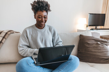 Black woman, laptop and remote work in living room for elearning, subscription info and social...